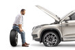 © Ljupco Smokovski - Profile shot of a pensive man sitting on a tire in front of his vehcile with open hood