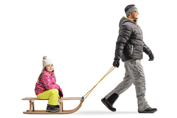 Sticker - Full length profile shot of a father pulling a girl on a wooden sled