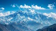 A majestic mountain range, with snow-capped peaks towering against a backdrop of clear blue skies