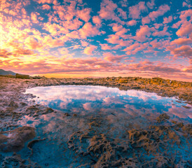 Wall Mural - Reflections at sunset near traditional pictorial coastal fishing village of Vlichadia, Crete, Greece.