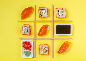 Creative Arrangement of Sushi and Sashimi on Yellow Background for Japanese Cuisine Concep