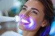 A radiant woman's captivating smile reveals her impeccable oral hygiene, accentuated by a bold lipstick and fluttering eyelashes, as she basks in the warm glow of indoor lighting