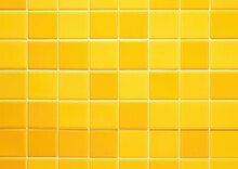A Yellow Tile Wall With Squares Of Different Sizes. Generative AI.