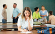 © JackF - Angry woman university student gazing at camera during recess in classroom.