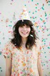 © ChaoticMind - A girl's joy radiates as she dons a party hat, adding a playful touch to her fashionable ensemble against the backdrop of a wall