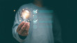 © krungchingpixs - Concept of successful business and thinking solution strategy. Businessman holding glowing light bulb and have checklist for solving problem. Check and solution list to business target.