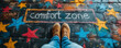 Personal growth and self-improvement concept with feet standing at the edge of a chalk-drawn circle labeled comfort zone surrounded by colorful stars