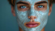 Intense gaze of a young individual with a purifying facial treatment mask
