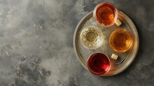 From Above, A Scene Presents Three Distinct Varieties Of Georgian Dry Wine Glasses White, Amber, And Red Resting On A Plate Accompanied By A Corkscrew.