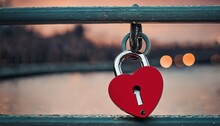 Romantic bridge scene with a red padlock and an adjoining heart-shaped love lock
