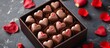 Valentine's Day gift with heart-shaped chocolates in a square box.