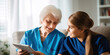 © SHOTPRIME STUDIO - Smiling Caregiver Assisting Elderly Patient in Nursing Home