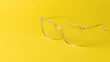 © kvladimirv - Stylish transparent glasses on a yellow background.