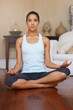© Miko/peopleimages.com - Yoga, meditation and portrait of woman in home in lotus for training, exercise and zen mindset. Fitness, mental health and person in yogi pose for wellness, mindfulness and pilates in living room