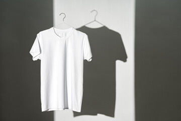 Wall Mural - Blank T-shirt hanging in a spotlight in studio