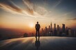 © YOUR - Businessman standing on top building and looking at sunset, business successful