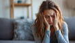 © Mirador - Overwhelmed at Home: Young Woman Gripping Head in Distress