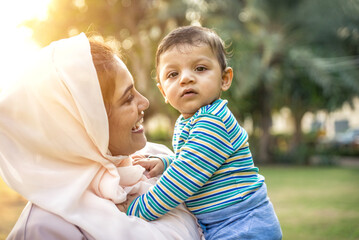 Wall Mural - Mother and baby son lifestyle moments in Dubai. Young woman with her kid outdoor. Family concepts in the UAE