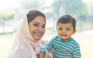 Wall Mural - Mother and baby son lifestyle moments in Dubai. Young woman with her kid outdoor. Family concepts in the UAE