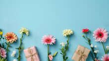 Spring Composition With Pink Flowers And Gift Boxes On A Blue Background With Copy Space On Top, Top View.