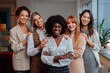 © bernardbodo - Team of diverse businesswomen posing together and laughing