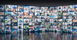 © Photocreo Bednarek - Digital wall with screens featuring various people. Modern global communication and network