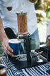 a man making coffee from aram coffee machine