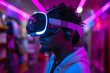A man immerses himself in virtual reality, puts on a futuristic headset and glasses and is immersed in a digital adventure.
