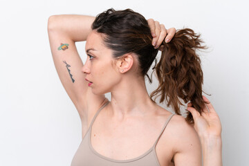 Wall Mural - Young caucasian woman isolated on white background touching her hair. Close up portrait