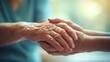 A close-up of a reassuring healthcare worker's hand clasping a patient's hand, symbolizing care and comfort in a medical setting.