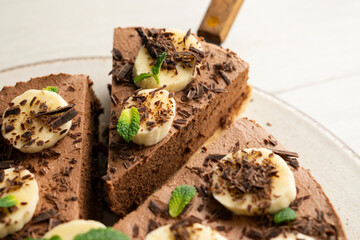 Wall Mural - Delicious and fluffy chocolate mousse cake with banana and orange aroma.