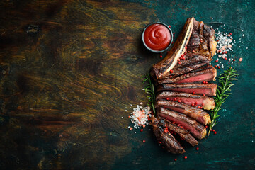 Wall Mural - Sliced grilled meat steak Rib eye medium rare set, on wooden serving board. Top view.