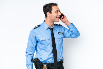 Wall Mural - Young police caucasian man isolated on white background keeping a conversation with the mobile phone