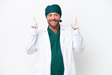 Wall Mural - Middle age surgeon in green uniform isolated on white background pointing up a great idea