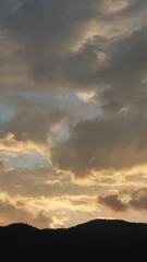 Wall Mural - breathtaking scene of the sun setting over the majestic mountains time lapse video, painting the sky