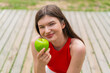© luismolinero - Young pretty woman at outdoors holding an apple