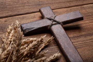 Poster - Wood cross and golden wheat on desk