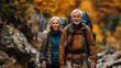 © VicPhoto - Pareja de  50 años andando por la montaña con ropa de montañero, mochila y gorro