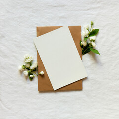 Canvas Print - Blank greeting card, invitation and envelope mockup. Minimal floral frame made of jasmine flower branch. Flat lay, top view. Happy mother's day, women's day or birthday, wedding composition.