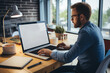© imagemir - Side view of young businessman in eyeglasses using laptop while sitting at table in office