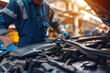 © ffunn - Auto mechanic working on car broken engine in mechanics service or garage