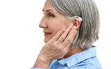 Fototapeta Tulipany - Middle-age woman with hearing impairment using hearing aid, side view. Hearing solutions for deafness people