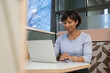 © Cultura Creative - Smiling mature businesswoman working on laptop in office