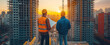 © LeManna - Worker and architect holding blueprints and looking on the construction of buildings. Engineering and industry concept.