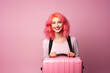 Young pink haired woman over isolated colorful background holding a suitcase