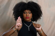 black woman gestures with her hand for help, denounces aggression, cowardice, violence against women, no to racism