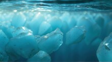 Submerged Ice Cubes In Blue Water. Close-up Of Ice Cubes Partially Submerged In Crystal-clear Blue Water, Depicting Cold And Freshness.