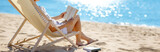 Fototapeta Na ścianę - Woman sitting with book in the chaise lounge on the sea beach.