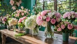 Many bouquets in the flower shop on the table of hydrangea, roses, peonies, eustoma in pink