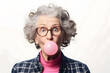 Elderly  woman chewing pink bubble gum